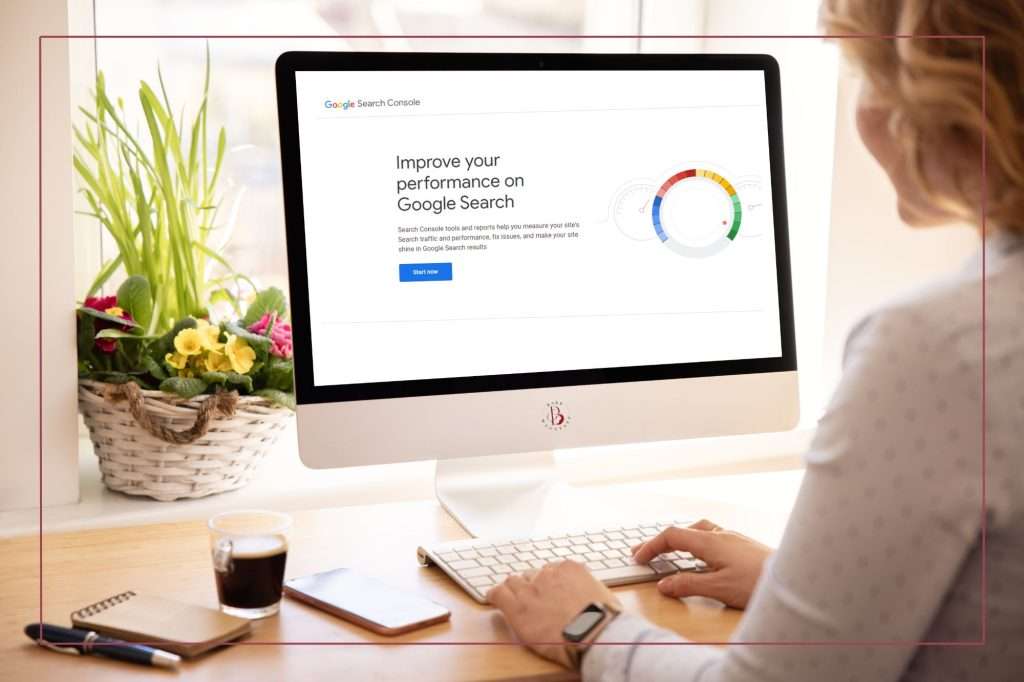 woman at her desk looking at a screen showing the Google Console homepage. 