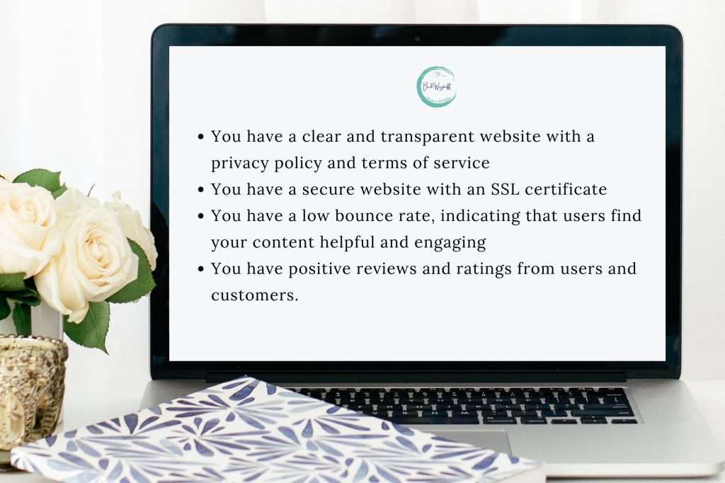 white roses in a gold vase on a table with a blue and white notebook and a laptop that reads "• You have a clear and transparent website with a privacy policy and terms of service • You have a secure website with an SSL certificate • You have a low bounce rate, indicating that users find your content helpful and engaging • You have positive reviews and ratings from users and customers."