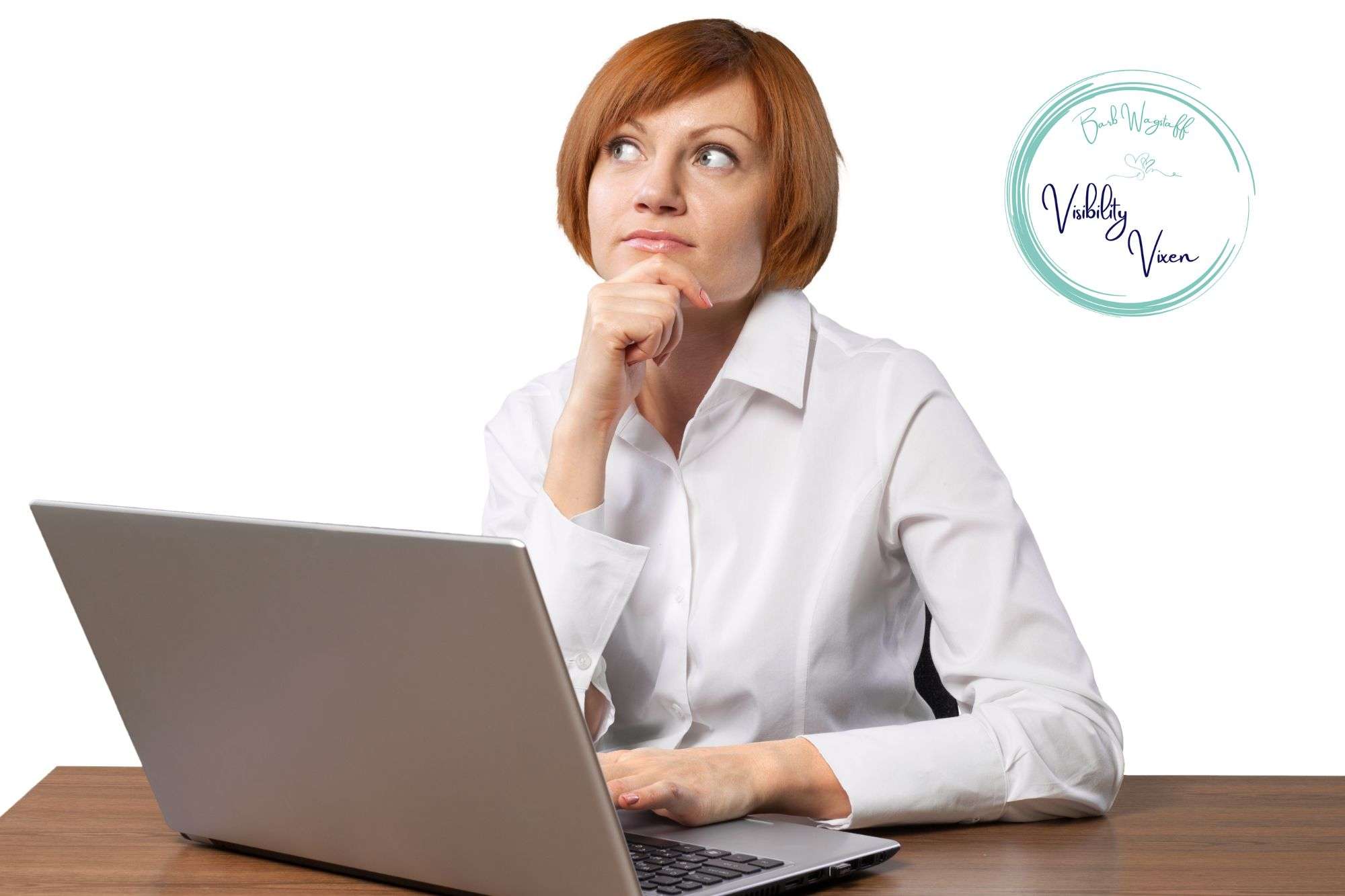 woman with reddish hair looking up from her computer. Her hand placed under her chin in reflection. Her laptop sits on a brown, wooden desk. A logo in the top right reading "Barb Wagstaff The Visibility Vixen"