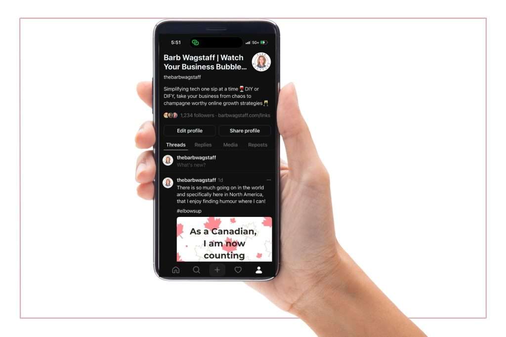 hand holding a cellphone open to a Threads home page. 