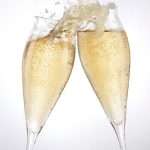 two champagne glasses toasting to success
